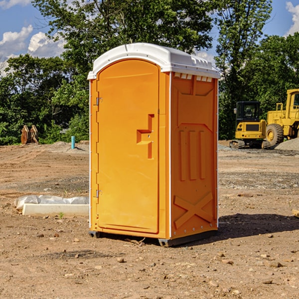 what is the cost difference between standard and deluxe portable restroom rentals in Gilman